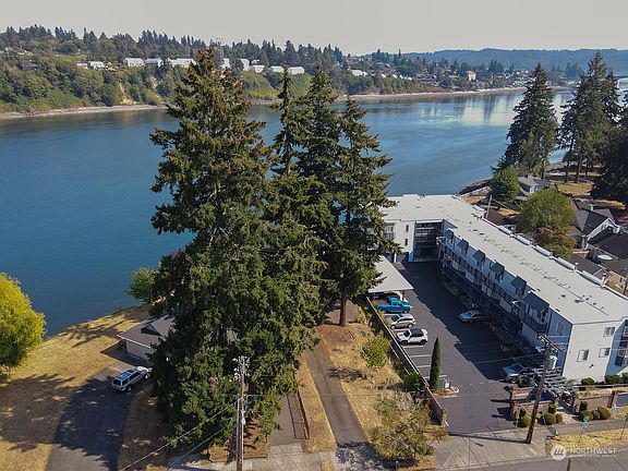 Drone shot from above house.  Evergreen park can be seen on the right.  Includes Public Boat Ramp .  >