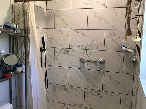 Newly completed walk in shower, toilet,vanity and flooring in Master Bdrm.