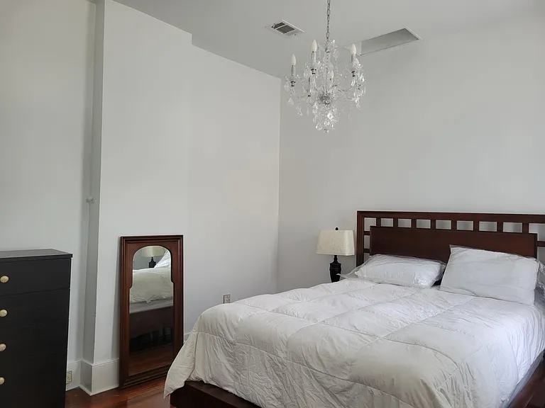 Upstairs bedroom #3 with dresser, mini split for ac/heater, access to balcony