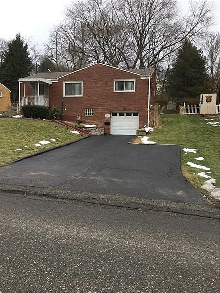 Exterior front showcasing level driveway/extra parking pad