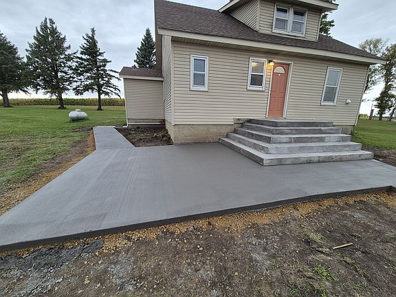 Spacious patio with East and South views. Sidewalk on the South leads to basement.