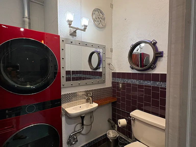 Washer/Dryer located in half bathroom.