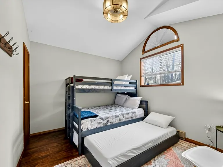 Family-Friendly Third Bedroom _ Featuring a twin-over-full bunk bed and pull-out trundle, this room offers a fun and comfortable space for children, guests, or larger groups.