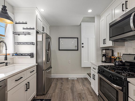 Kitchen with all new appliances and bar stool seating for 2