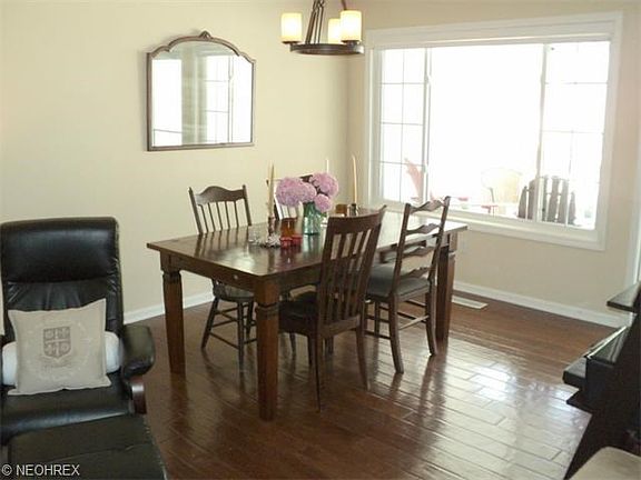 Light and bright dining room with hardwood flooring.