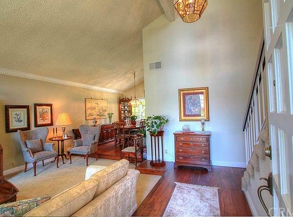 High quality newer hardwood flooring and plush carpet make this living room warm and inviting.
