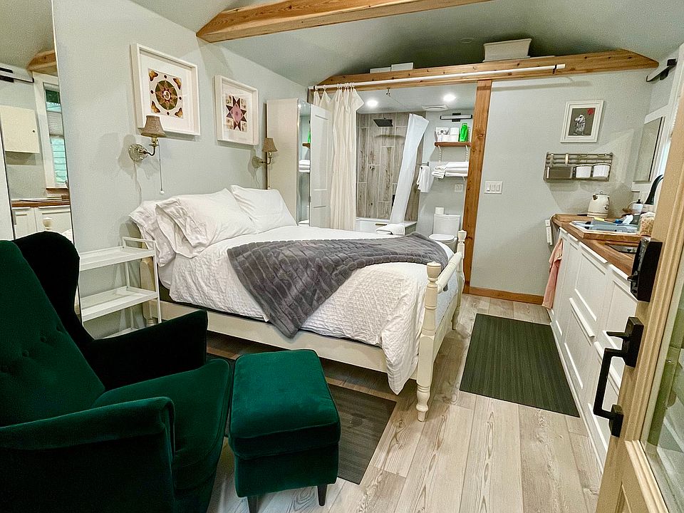 Studio interior. Tall wardrobes on either side of full size bed.