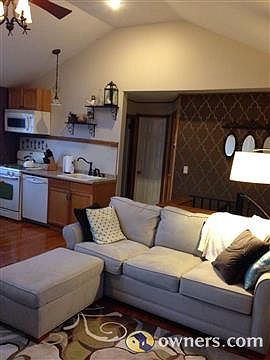 combination kitchen/living room with vaulted ceiling