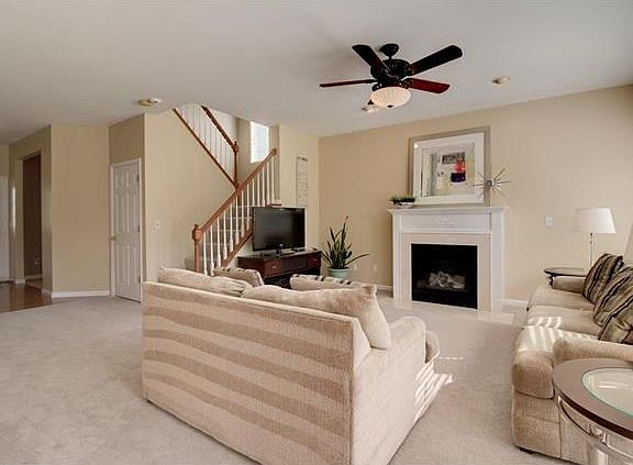 Spacious Great Room with gas fireplace, wall of windows and open staircase to upper level!