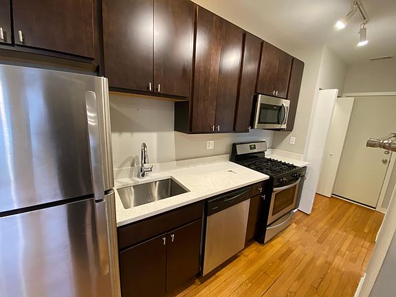Modern updated kitchen with white quartz countertops