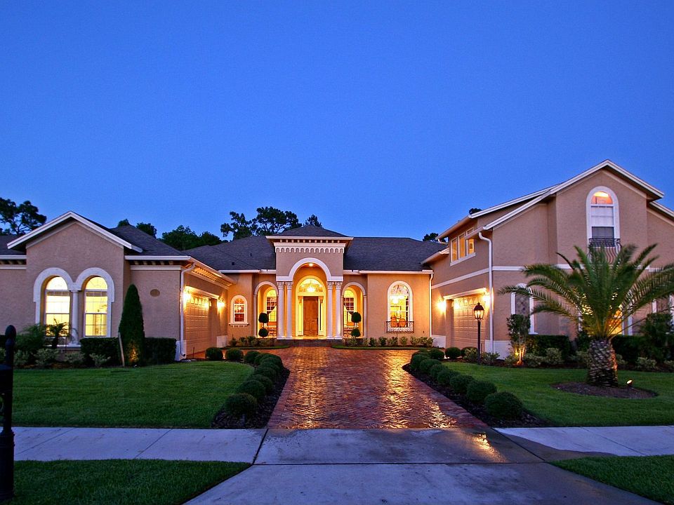 Welcome home! A graceful porch with beautiful stonework and columns greets you