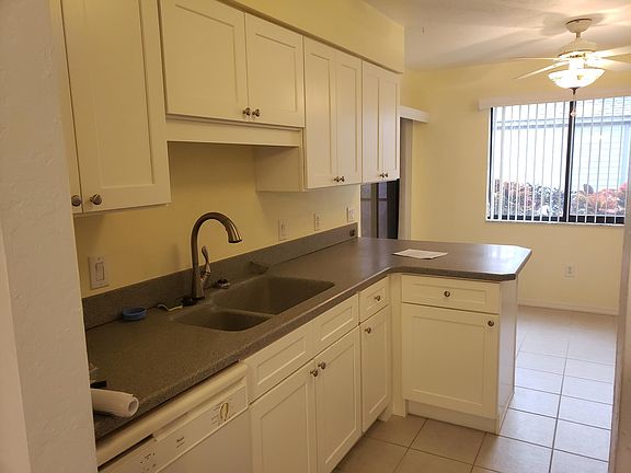 Kitchen from the dining room entrance. Eat in area with sliders to the porch near window.