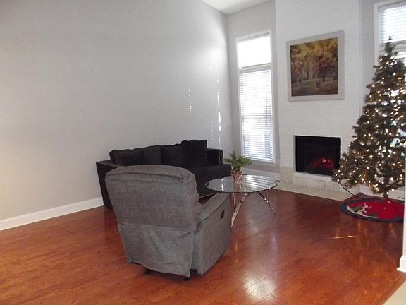 Spacious Vaulted Great Room Features Fireplace, Laminate Flooring, Plenty of Space for Dining area and opens to newly remodeled Kitchen
