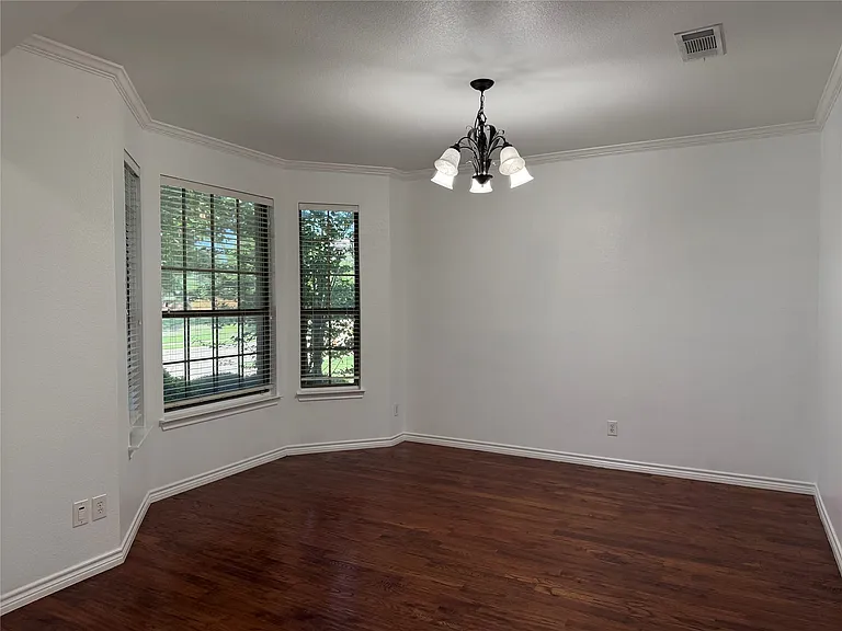 Formal dining room with bay windows.