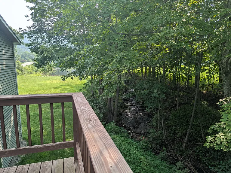 Private deck overlooking a stream and pond