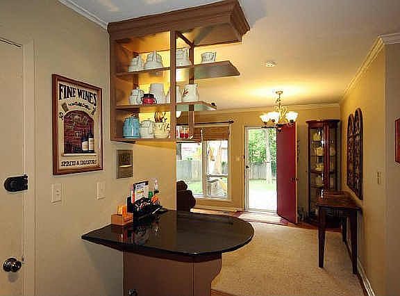 Elegant black granite and blonde wood make this island a warm place to enter.