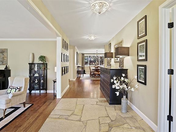 The entrance to this home is spacious and welcoming.  You'll love the beauty of this original flag stone entry.  That's the living room on the left and the door to the master bedroom is pictured  on the right.