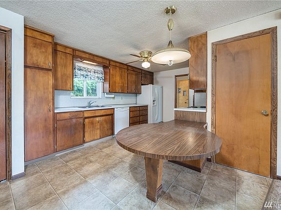 Kitchen has lots of cabinetry and built-in table