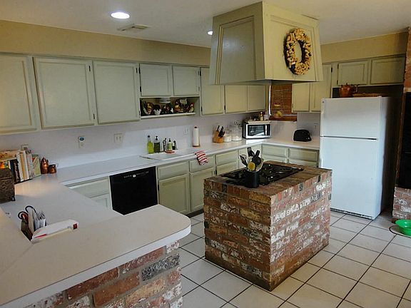 The kitchen has tons of counter and cabinet space, the island houses the stovetop and more counter space to prep meals!