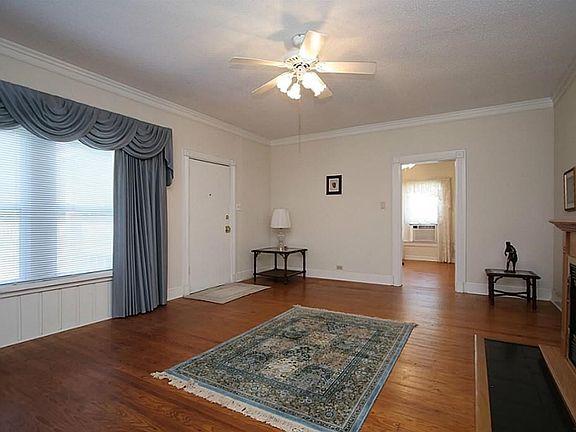 The living room features beautiful hard wood floors and fireplace.