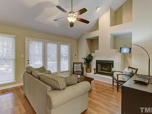 Living room with cathedral ceilings, gas fireplace, windows spanning the back deck
