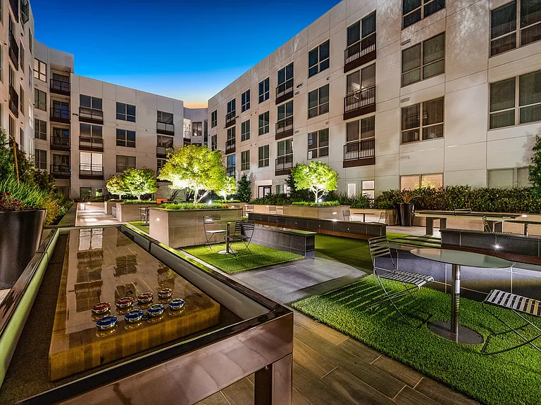 Courtyard game lounge with shuffleboard table and seating