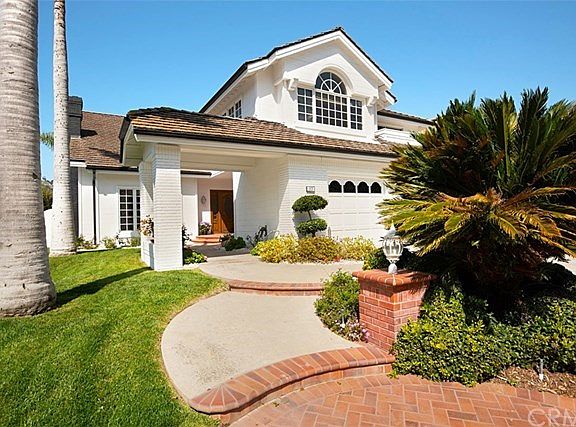 Another view of the beautiful entry way and lush landscaping.