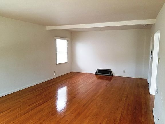 Living area view 1 with hardwood floors.