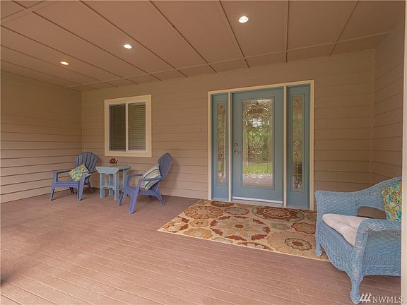 Large covered entry porch with beautiful insulated stained glass door w/sidelights