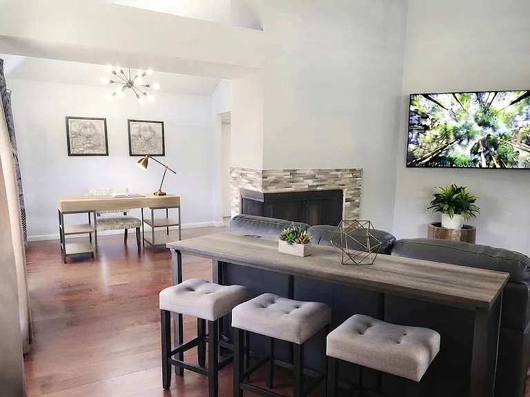 Living room features two seating areas, console table area, TV etc