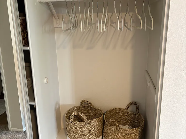 Large closet with hangers and baskets