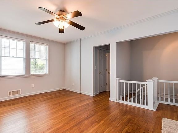 Spacious living room with newly refinished floors