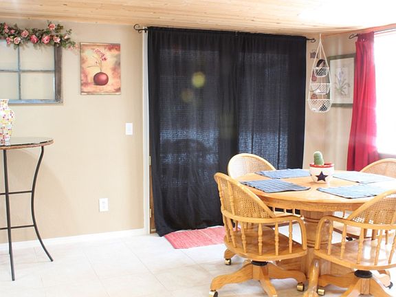 The dining area is open to the kitchen. Sliding glass doors lead to back yard deck.