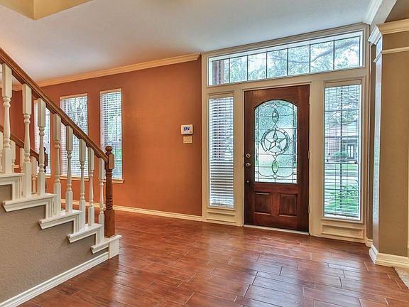 Stunning entry with gleaming hardwoods in the foyer continuing into the den and dining room.