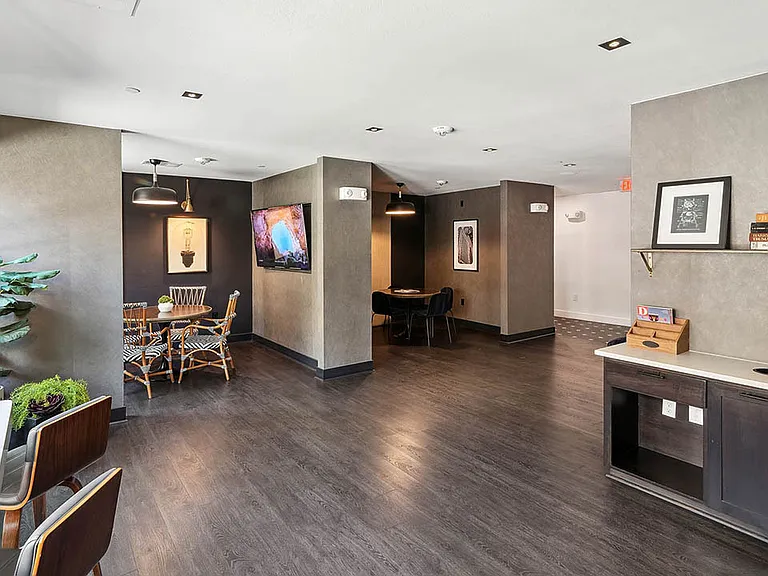 Wifi lounge with office printer, working stations, and wood style floor.