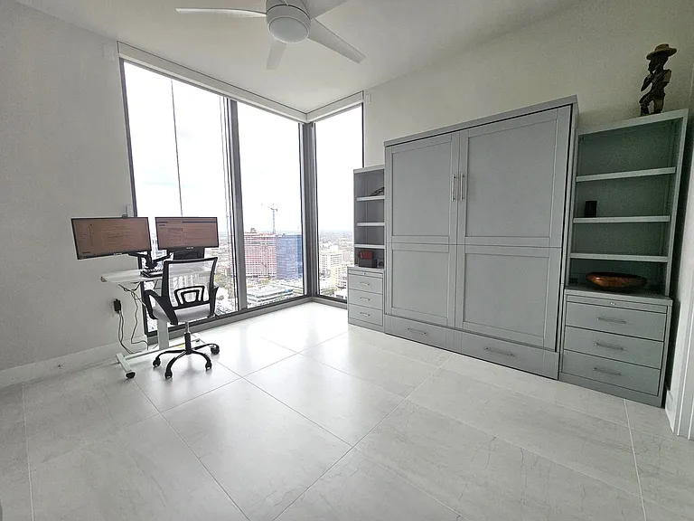 Second bedroom with queen murphy bed, rollable up / down desk with thunderbolt plug in (bring your laptop, plug in and you have twin large monitors, full size keyboard, and mouse.