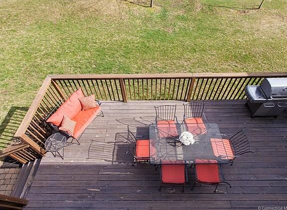 Spacious deck is situated right off the kitchen through the sliding glass doors and in the back yard.