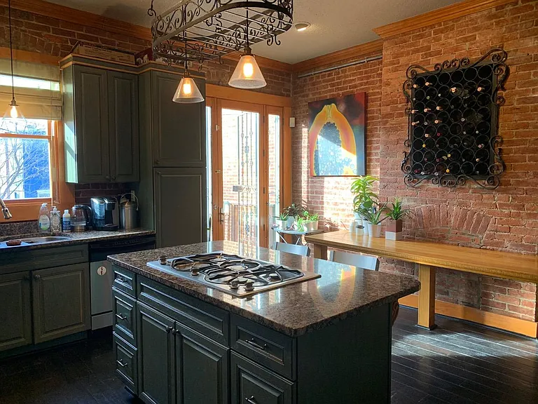 Kitchen with built in wine rack and table.