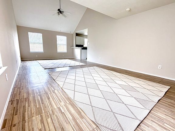 Large living room with high vaulted ceiling.