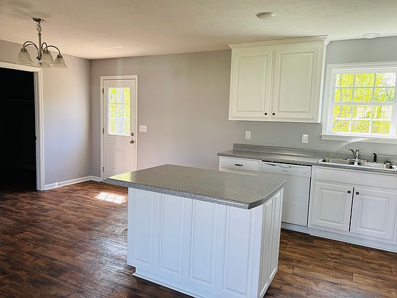 Kitchen with island and a dining area nearby