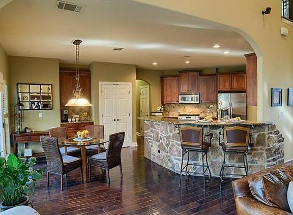 The beautiful Chef's kitchen is perfect for entertaining! The rich warmth of the wooden flooring is 