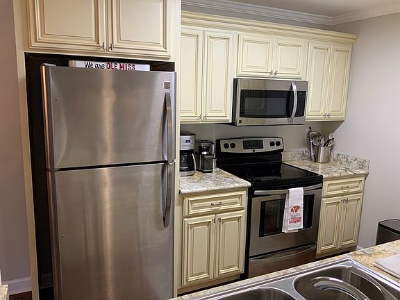 View from living room to kitchen. (please note items on counter not included)