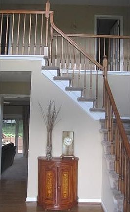 Graceful turned staircase in wide foyer entry