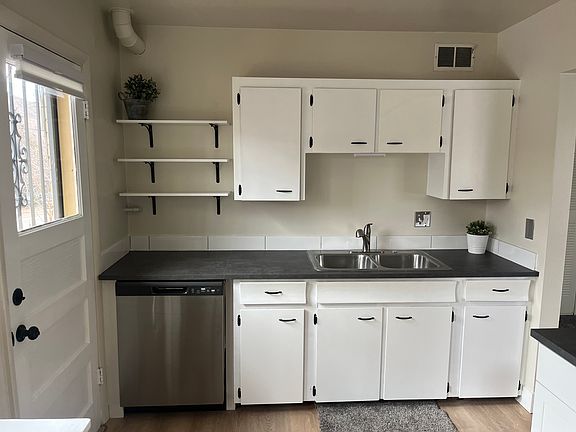 Kitchen features new IKEA countertops and open shelving.
