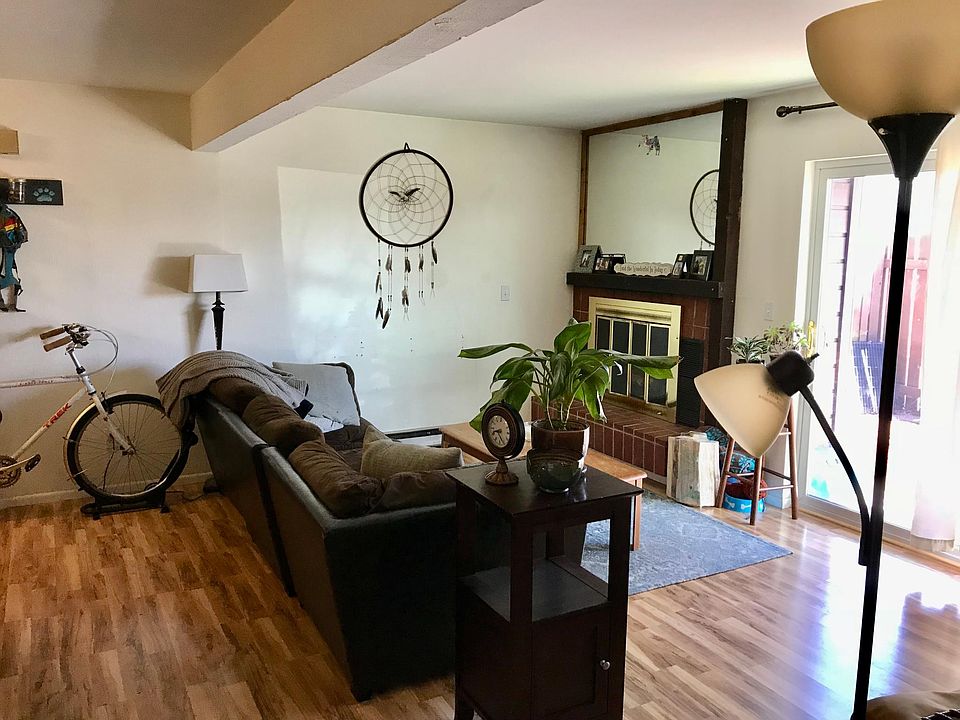 Living room w/ fireplace and large slider.