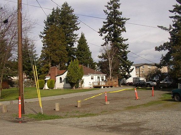 East property boundary approx. at power pole - property to right in photo is slightly smaller parcel