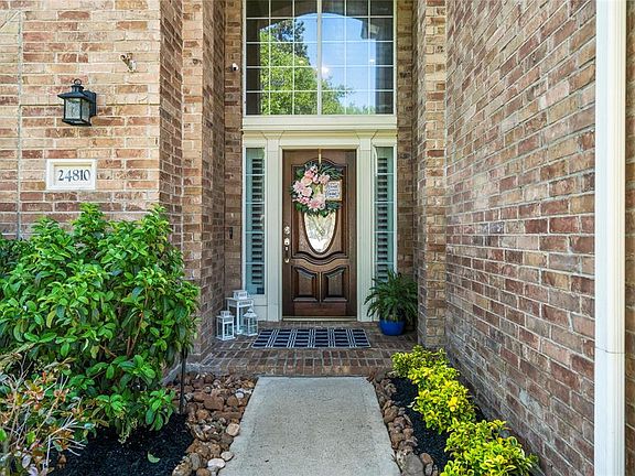 Covered front porch and beautiful front door make guests feel welcome.