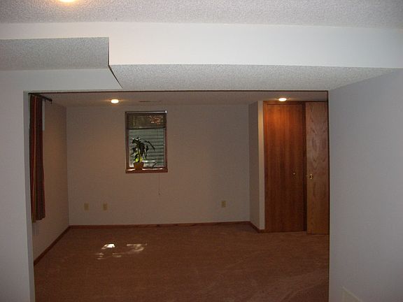 Lower 4th bedroom w/new carpeting and egress window.