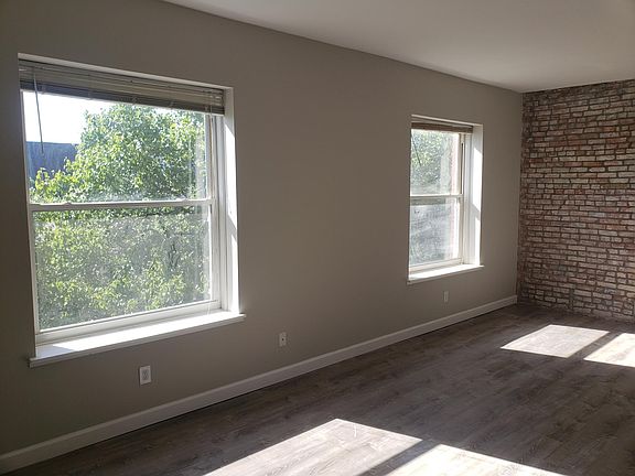 Living room with two large windows looking out at a historic church.