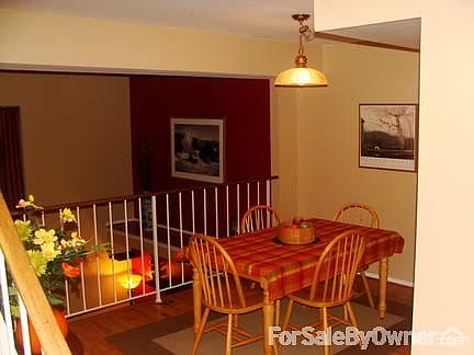 Dining Room
						:
						Dining room features wood laminate floors and overlook to the family room.